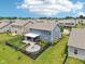 Aerial view of backyard with fire pit, patio, landscaping, and fenced yard at 220 Sawdust Trl, Greenfield, IN 46140