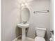 Powder room featuring a pedestal sink, oval mirror, and a toilet against a neutral painted wall at 220 Sawdust Trl, Greenfield, IN 46140