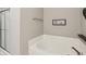 Bright bathroom showcases a soaking tub, glass shower, and elegant wall decor at 220 Sawdust Trl, Greenfield, IN 46140