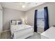 Cozy bedroom showcasing a bed with accent pillows, carpeted floors and blue curtains at 220 Sawdust Trl, Greenfield, IN 46140