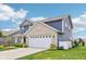Charming home with a well-manicured lawn, two-car garage, and inviting curb appeal at 220 Sawdust Trl, Greenfield, IN 46140