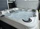 Inviting hot tub with swirling water and comfortable headrests, perfect for relaxation and unwinding outdoors at 220 Sawdust Trl, Greenfield, IN 46140