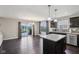 Bright eat-in kitchen featuring stainless steel appliances, dark wood cabinetry, and access to backyard patio at 220 Sawdust Trl, Greenfield, IN 46140
