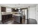 Modern kitchen with dark wood cabinets, stainless steel appliances, and a center island at 220 Sawdust Trl, Greenfield, IN 46140