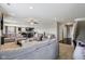 Open-concept living room with neutral carpet, cozy furniture, and seamless flow to the kitchen and dining area at 220 Sawdust Trl, Greenfield, IN 46140