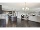 Open-concept kitchen and living room with hardwood floors and stainless steel appliances at 220 Sawdust Trl, Greenfield, IN 46140