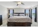 Spacious main bedroom with neutral colors, ample natural light, and a ceiling fan at 220 Sawdust Trl, Greenfield, IN 46140