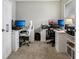 Bright office space with dual workstations, carpet, natural light, and ample storage, perfect for productivity at 220 Sawdust Trl, Greenfield, IN 46140