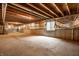 Unfinished basement with concrete floor, exposed ceiling, and window at 2209 S Logan Dr, New Palestine, IN 46163