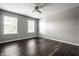Bright bedroom featuring neutral walls, two windows, and dark hardwood floors at 2209 S Logan Dr, New Palestine, IN 46163