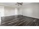 Spacious bedroom with neutral walls and dark hardwood floors, complemented by a ceiling fan at 2209 S Logan Dr, New Palestine, IN 46163
