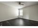 Bright bedroom with neutral walls, a window, and dark hardwood floors at 2209 S Logan Dr, New Palestine, IN 46163