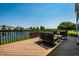 Outdoor deck area with comfortable seating and a view of the serene pond and landscape at 2209 S Logan Dr, New Palestine, IN 46163