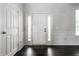 Bright entryway with hardwood floors, a white door with sidelights, white trim, and neutral colored walls at 2209 S Logan Dr, New Palestine, IN 46163