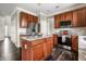 Kitchen with an island, stainless steel appliances, granite countertops, and dark wood cabinetry at 2209 S Logan Dr, New Palestine, IN 46163