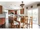 Spacious eat-in kitchen with sliding doors to deck, stainless steel appliances, and granite countertops at 2209 S Logan Dr, New Palestine, IN 46163