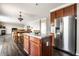 Spacious kitchen with island, stainless steel refrigerator, and open view to the dining and living areas at 2209 S Logan Dr, New Palestine, IN 46163