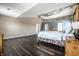 A spacious main bedroom features high ceilings and wood floors, creating an open and airy atmosphere at 2209 S Logan Dr, New Palestine, IN 46163