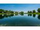Beautiful view of a serene pond reflecting the blue sky and surrounding greenery at 2209 S Logan Dr, New Palestine, IN 46163