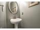 Charming powder room with pedestal sink, mirror, and stylish decor at 2209 S Logan Dr, New Palestine, IN 46163