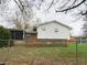 Fenced backyard features a wooden deck adjacent to the house, offering outdoor living and entertainment space at 2414 Constellation Dr, Indianapolis, IN 46229