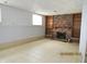Finished basement with tile flooring, a brick fireplace, and built-in bookshelves at 2414 Constellation Dr, Indianapolis, IN 46229