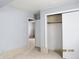 Bedroom featuring tile flooring, base molding, closet, and ensuite access at 2414 Constellation Dr, Indianapolis, IN 46229