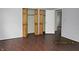 Bedroom features wood-look floors, neutral paint, and a closet with folding doors at 2414 Constellation Dr, Indianapolis, IN 46229