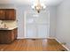 Dining area featuring a sliding glass door, chandelier, and wood-look flooring at 2414 Constellation Dr, Indianapolis, IN 46229