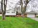 Charming two-story home with brick and siding exterior, a well-manicured lawn, and a two-car garage at 2414 Constellation Dr, Indianapolis, IN 46229