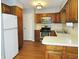 Traditional kitchen featuring wood cabinets, laminate countertops, and white appliances at 2414 Constellation Dr, Indianapolis, IN 46229