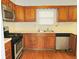 The kitchen has wood cabinets, stainless steel microwave, and matching black appliances at 2414 Constellation Dr, Indianapolis, IN 46229