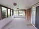 Enclosed porch with carpet floors, white wainscoting, and multiple windows providing natural light and outdoor views at 2414 Constellation Dr, Indianapolis, IN 46229