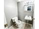 Bathroom with tile floors, toilet, and single sink with mirror and vanity lights at 2419 Tamarack Pl, Anderson, IN 46011