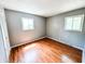 Bright bedroom with wood floors and ample natural light from two windows at 2419 Tamarack Pl, Anderson, IN 46011