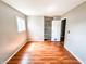 Bedroom featuring hardwood floors, a window, and a closet with an open door at 2419 Tamarack Pl, Anderson, IN 46011