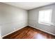 Bedroom with hardwood floors, grey walls, and bright natural light from the window at 2419 Tamarack Pl, Anderson, IN 46011