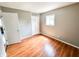 Cozy bedroom featuring hardwood floors, neutral walls, and a closet with paneled doors at 2419 Tamarack Pl, Anderson, IN 46011