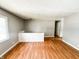 Bright living room with new wood flooring and ample natural light from large window at 2419 Tamarack Pl, Anderson, IN 46011