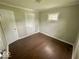 Clean and bright bedroom with wood floors, neutral paint, and ample closet space at 2624 E 17Th St, Indianapolis, IN 46218