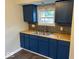 Stylish kitchen featuring dark blue cabinets, butcher block countertops, and a subway tile backsplash at 2624 E 17Th St, Indianapolis, IN 46218