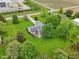 An aerial view shows the home with a sprawling green lawn, mature trees, and a cozy back deck area at 3020 E 400 S, Lebanon, IN 46052