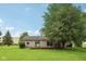 Spacious backyard featuring a large tree and outdoor seating area, perfect for leisure at 3020 E 400 S, Lebanon, IN 46052