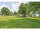 Expansive backyard featuring lush greenery, mature trees and deck with outdoor seating at 3020 E 400 S, Lebanon, IN 46052