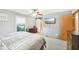 Serene bedroom featuring soft gray walls, ceiling fan, and doorway to en-suite bathroom at 3020 E 400 S, Lebanon, IN 46052