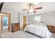 Well-lit bedroom featuring ceiling fan, neutral walls, and en suite bathroom access at 3020 E 400 S, Lebanon, IN 46052