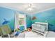 Bright, ocean-themed bedroom featuring a white crib and a cheerful mural at 3020 E 400 S, Lebanon, IN 46052