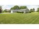 Single story home with a one car garage surrounded by a large manicured lawn and mature trees at 3020 E 400 S, Lebanon, IN 46052