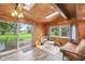 Inviting sunroom with wooden ceiling, skylights, sliding door, and backyard view at 3020 E 400 S, Lebanon, IN 46052
