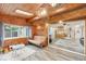 Cozy sunroom with wood paneled walls, a skylight, and views into adjacent rooms at 3020 E 400 S, Lebanon, IN 46052